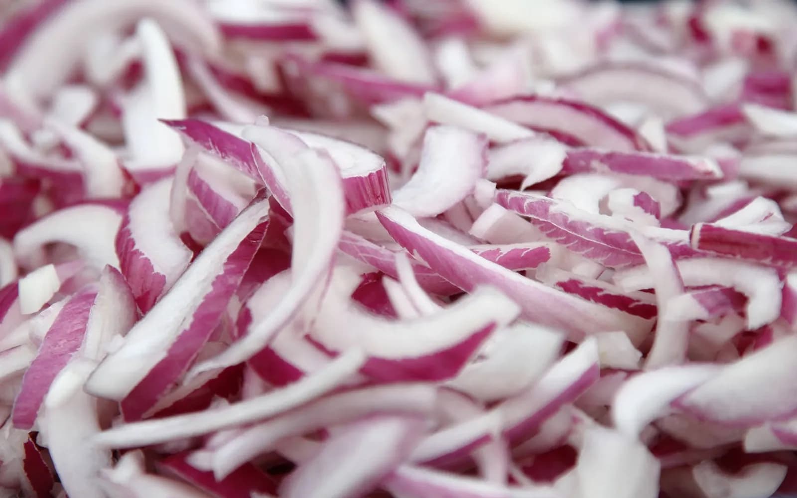 Freshly sliced red onion, prepared for retail and food manufacturing